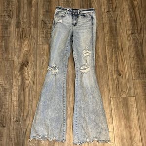 These are mid-rise flare jeans from flying monkey. They are a light wash color.